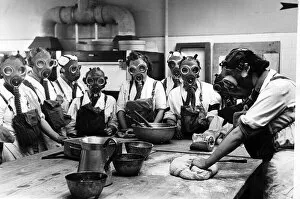 00155 Gallery: Women wearing gas masks while watching a cookery. June 1941