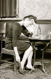 A women who has had to much to drink holds her head (posed by model) A women who has had to much to drink holds her head (posed by model)