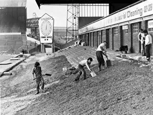 Workmen are busy preparing the ground before beginning work on the Railway End stand