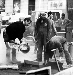 Workmen busy at some roadworks beside Newcastles Theatre Royal on 4th March 1989
