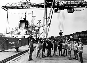 Workmen from Garston Stevedores lifting their hats to the success of their company Workmen from Garston Stevedores lifting their hats to the success of their company