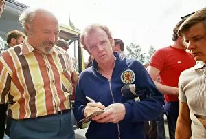 Images Dated 21st June 1974: World Cup 1974 Billy Bremner signing autographs after a Scotland training