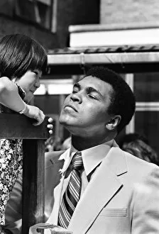 World Heavy-weight boxing champion Muhammad Ali with a little girl from Great Ormond