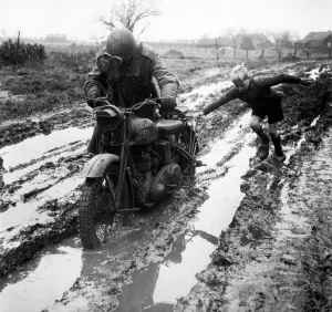 00492 Gallery: World War II Invasion of Holland A British army dispatch rider stuck in the mud gets a