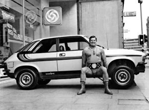 Wrestler Geoff Condliffe known as Count Bartelli lifting a car