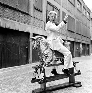 Images Dated 24th February 1975: Wrestler Jackie Pallo poses with a rocking horse. February 1975