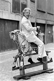 Images Dated 24th February 1975: Wrestler Jackie Pallo poses with a rocking horse. February 1975