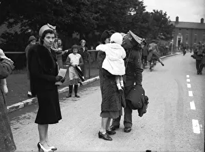 WW2 British Soldiers in England march along the road past families WW2 British Soldiers in England march along the road past families