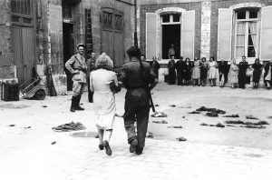 WW2 - A woman collaborator is led to the prefecture courtyard in Chartres WW2 - A woman collaborator is led to the prefecture courtyard in Chartres