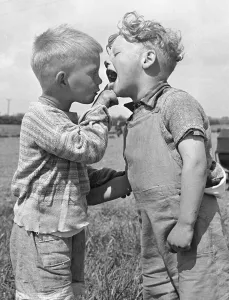 Four year old Keith Mackevitt (right) has his mouth checked by his friend Michael King Four year old Keith Mackevitt (right) has his mouth checked by his friend Michael King