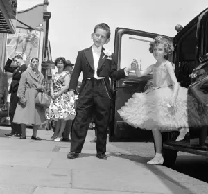 Ten year old Susan Millard wearing a crinoline style ball gown is helped out of her taxi Ten year old Susan Millard wearing a crinoline style ball gown is helped out of her taxi