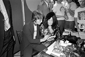Images Dated 15th July 1971: Yoko Ono launches new book: John Lennon signing copies of Grapefruit'