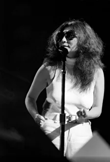 Images Dated 30th August 1972: Yoko Ono singing in a charity concert in New York with her husband John Lennon