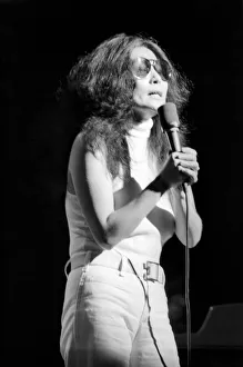 Images Dated 30th August 1972: Yoko Ono singing in a charity concert in New York with her husband John Lennon