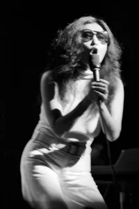 Images Dated 30th August 1972: Yoko Ono singing in a charity concert in New York with her husband John Lennon