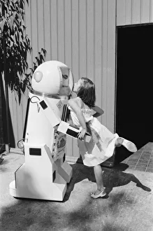 Robotic Gallery: Young Admirer Helen Dobbie, 8 years old from Hove, kisses, Denby the robot, which talks