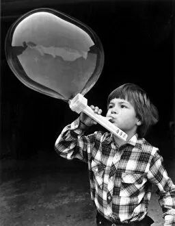 Young boy blowing bubbles. 7th March 1979