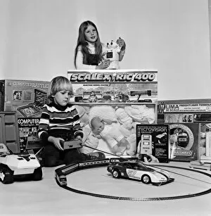 Images Dated 4th December 1980: A young boy and girl with a selection of childrens toys for Christmas. December 1980