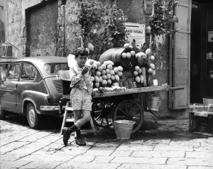 A young boy of Naples in Southern Italy selling goods on the side of the road A young boy of Naples in Southern Italy selling goods on the side of the road