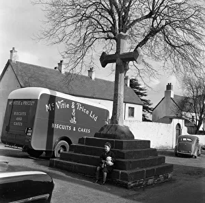 A young boy sitting on the steps of the City Cross, Llandaff Cathedral, South Wales A young boy sitting on the steps of the City Cross, Llandaff Cathedral, South Wales