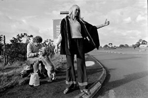 A young couple and their dog trying to hitch a lift on the motorway September 1970