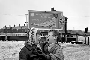 A young couple are highly amused by Nude Billboard Advert. December 1970 71-00003-004 A young couple are highly amused by Nude Billboard Advert. December 1970 71-00003-004
