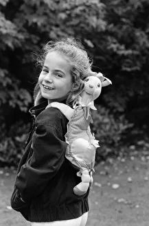 Images Dated 21st October 1986: A young girl wearing a soft toy rucksack. 21st October 1986