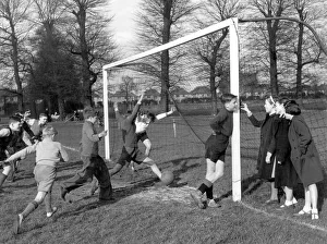 Young goalkeeper is distracted by a group of girls, as a goal is scored,, 20th April 1951 Young goalkeeper is distracted by a group of girls, as a goal is scored,, 20th April 1951