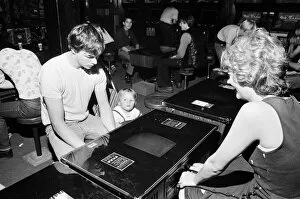 Images Dated 12th August 1981: Young holidaymakers play the video machines at the James Corrigan seafront amusement