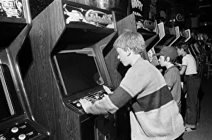 Images Dated 12th August 1981: Young holidaymakers play the video machines at the James Corrigan seafront amusement