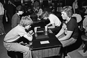 Images Dated 12th August 1981: Young holidaymakers play the video machines at the James Corrigan seafront amusement