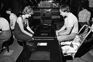 Images Dated 12th August 1981: Young holidaymakers play the video machines at the James Corrigan seafront amusement