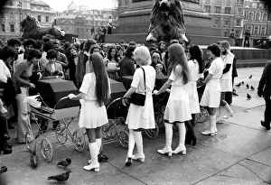 Six young ladies pushing prams on a sunny day in Trafalgar Square Six young ladies pushing prams on a sunny day in Trafalgar Square