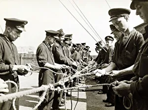 Young Sailors learning skills - September 1942, standing in line, tying knots with rope Young Sailors learning skills - September 1942, standing in line, tying knots with rope