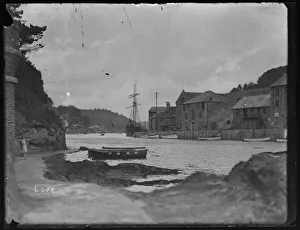 East Looe Quay with masted ship from harbour pathway East Looe Quay with masted ship from harbour pathway