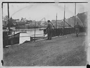 Fisherman hanging out nets on West Looe quay Fisherman hanging out nets on West Looe quay