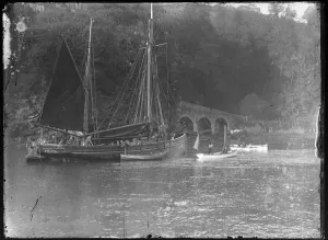 Masted boat being piloted in to Looe Harbour Masted boat being piloted in to Looe Harbour