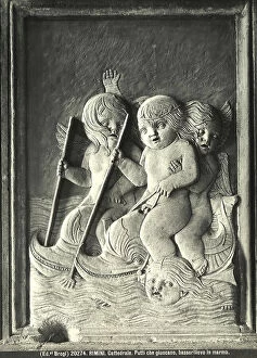 Putto Collection: Bas relief with winged putti playing while riding on dolphins