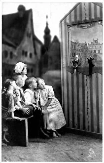 Park Bench Collection: Group of children enchanted by the puppet theater, postcard greeting card for Easter