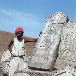 Images Dated 31st May 2007: Portrait of a man leaning on one of the tombs of the Rajput horsemen, Rajasthan