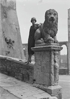 Images Dated 18th September 2012: Portrait of a woman near of a stone lion of Palazzo Orsini in Pitigliano