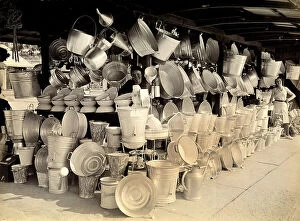 Images Dated 9th September 2010: A stand selling aluminum wares in Turin; the owners can be seen in the midst of the pots and pails