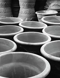 Terracotta vases with decorations visible on their surface, made by a company in Bologna