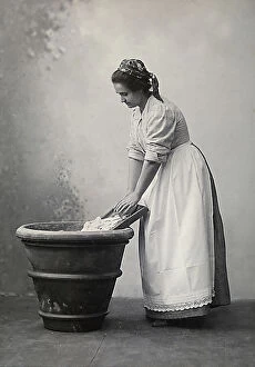Images Dated 22nd June 2009: A woman doing laundry in a large terracotta vase