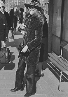 Retro Clothing Trends Prints: In the 1970s. A young woman in the street dressed in leather pants