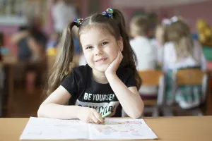 Prints of Belarus, the city of Gomil, May 10, 2019. Open day in kindergarten. Preschooler girl with a book. First-grader. Portrait of a kindergarten graduate Belarus Prints: Belarus, Gomil Print: Kindergarten Open Day May 10, 2019