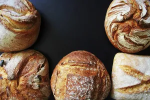 Bakery Products Prints: Bread. Assortment of different types of bread on a blackn background