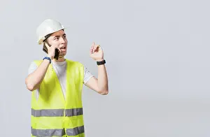 Civil Engineer Prints: Builder engineer in vest talking on cell phone isolated