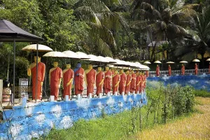 Golden Temple Prints: Dambulla, Sri Lanka Print - Golden Temple and Monk Statues