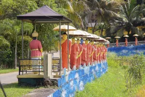 Golden Temple Prints: Dambulla, Sri Lanka Print: Golden Temple and Monk Statues